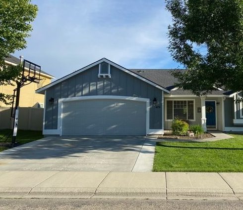 The same house repainted blue-grey with white trim