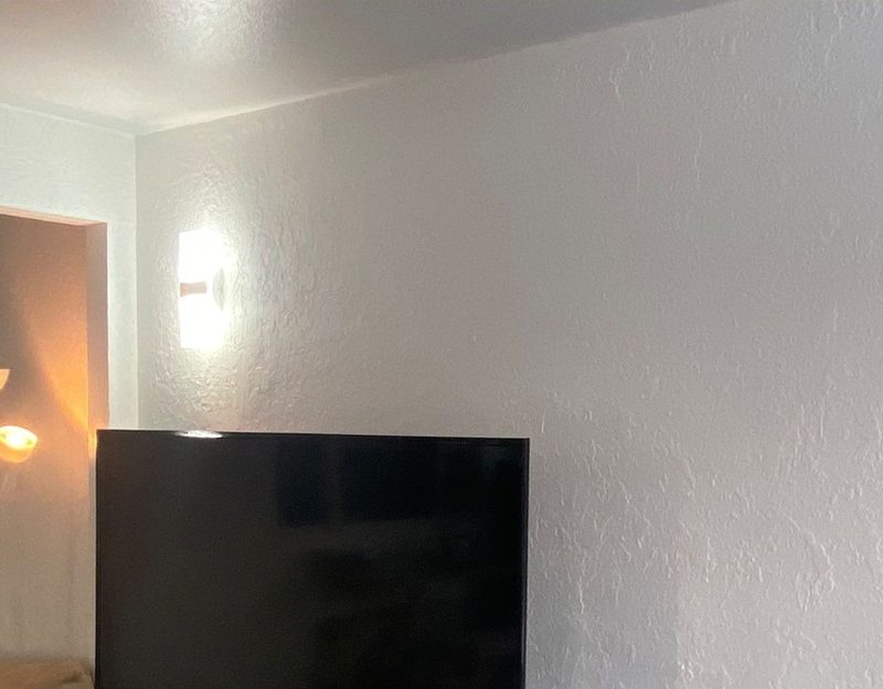 The wall repaired, textured and painted